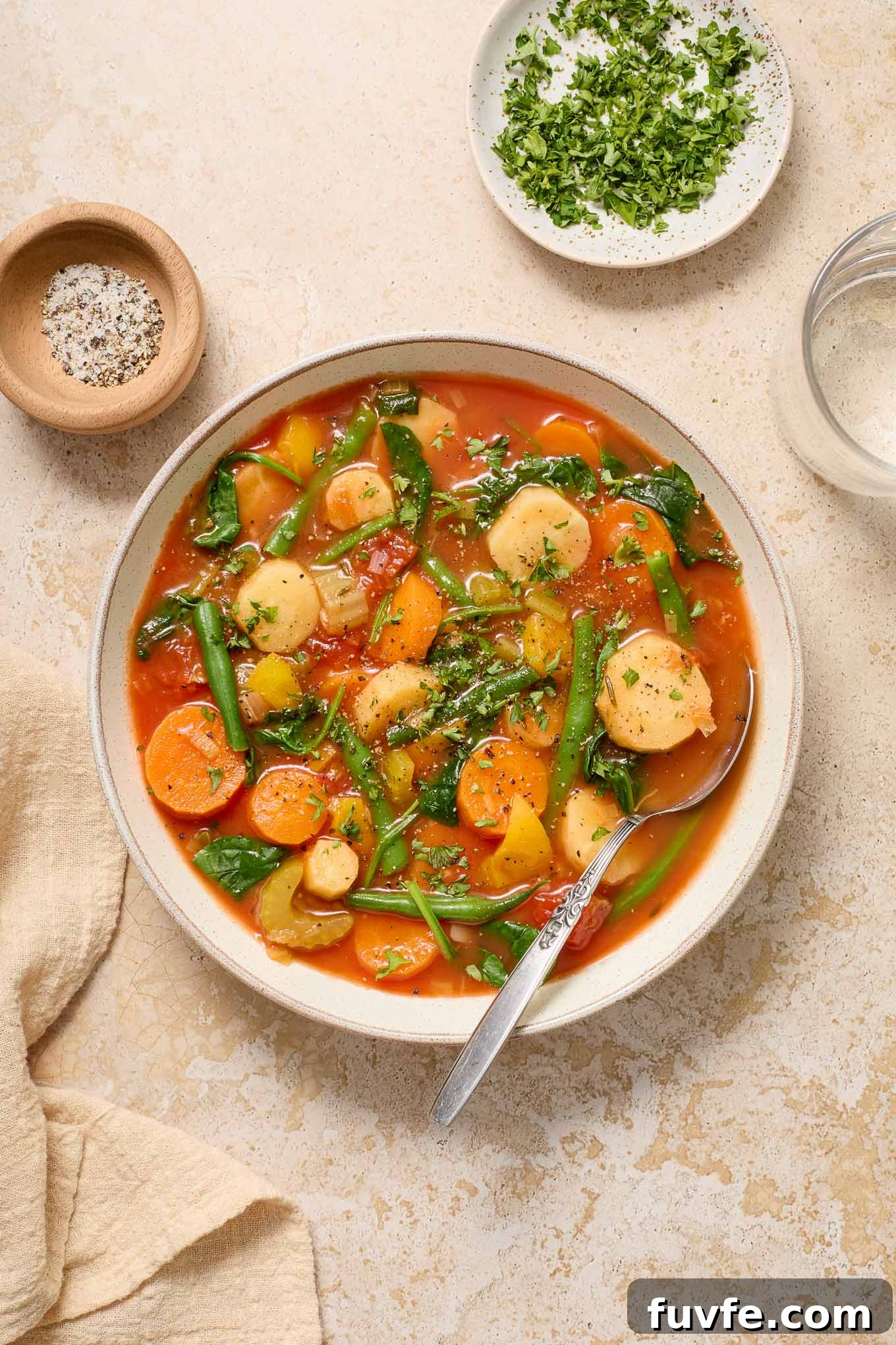 What's In Season in March: Fresh Produce Guide 25 Instant pot vegetable soup in a bowl with parsley and pepper.