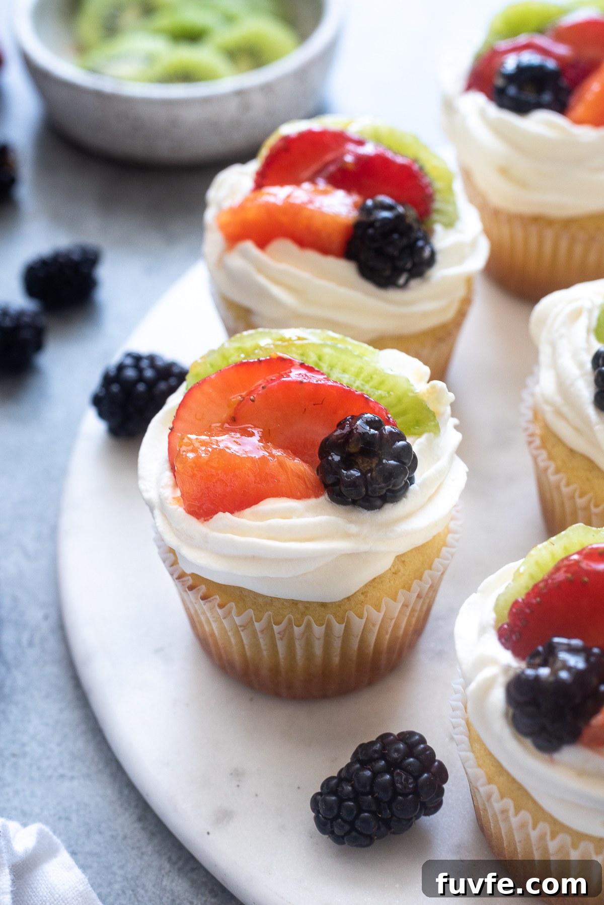 What's In Season in March: Fresh Produce Guide 44 Fruit tart vanilla cupcakes on a serving board.