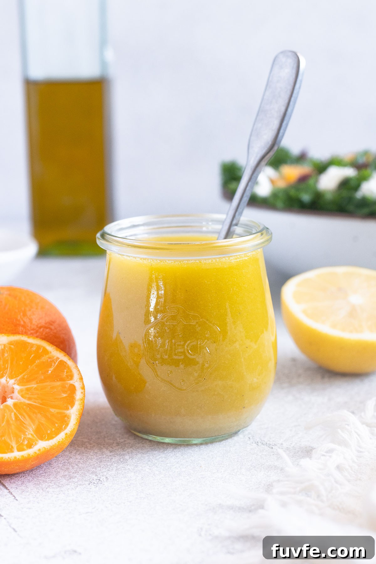 What's In Season in March: Fresh Produce Guide 48 Citrus vinaigrette in a jar with spoon inside.