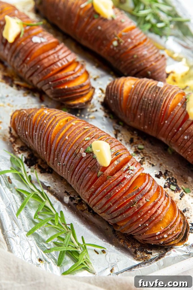 Hasselback sweet potatoes on a baking sheet
