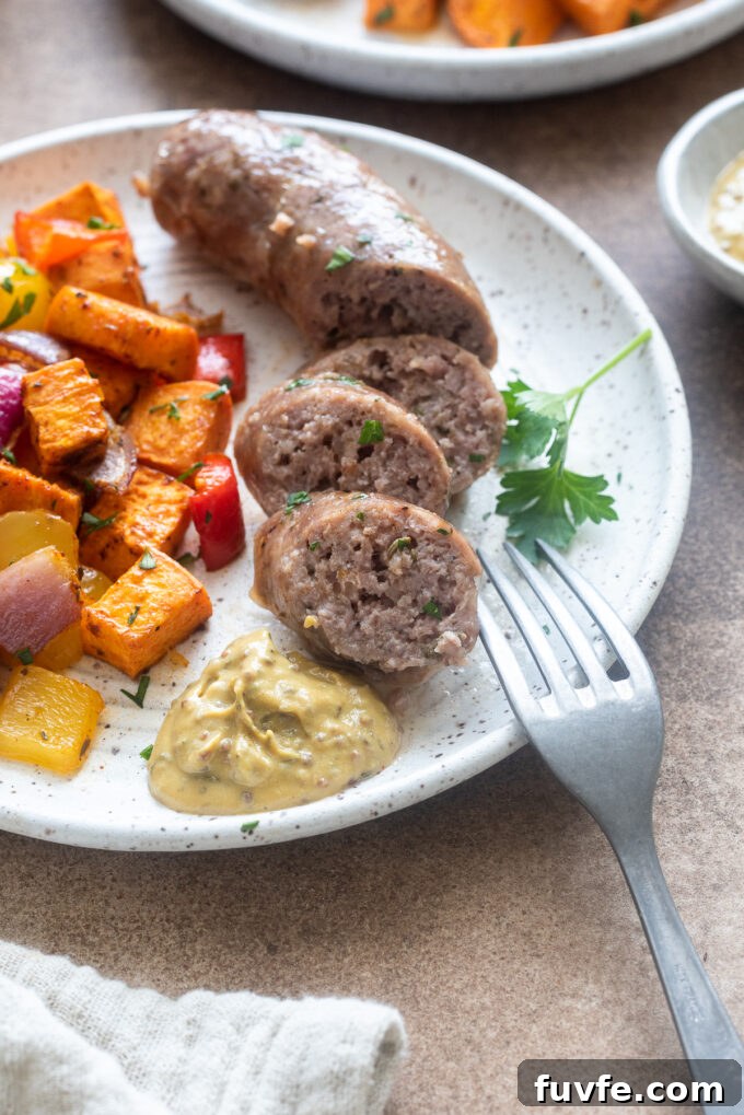 One pan sausage and veggies on a plate with grainy mustard.