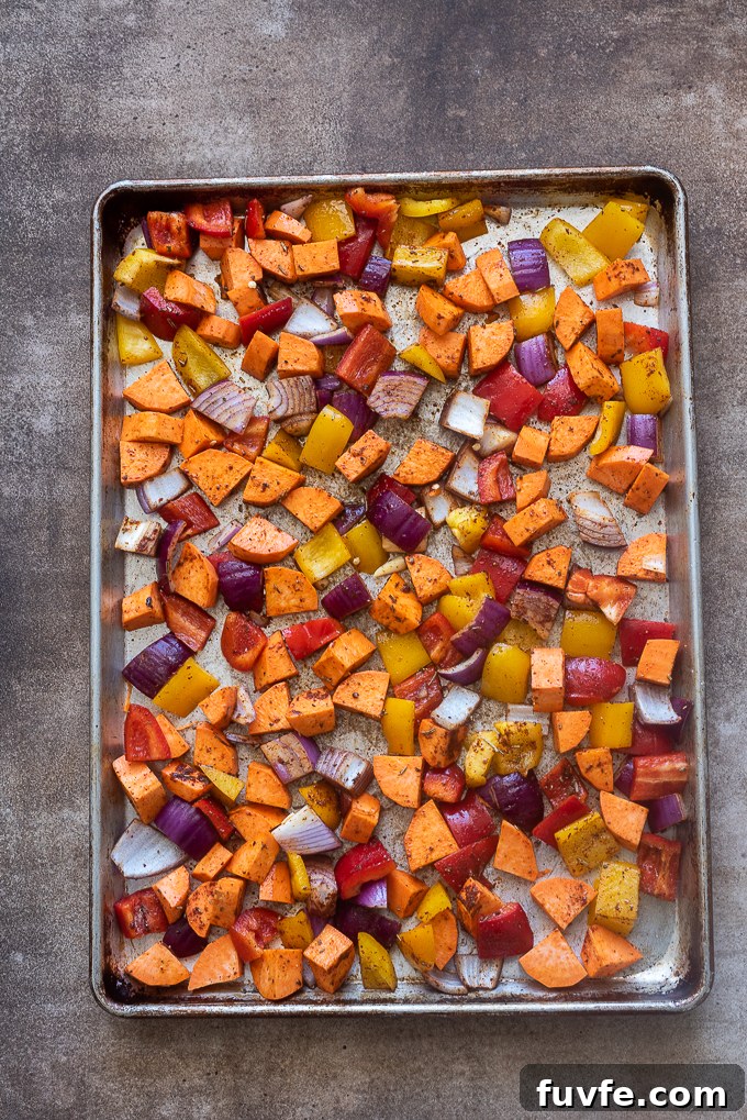 Seasoned vegetables on baking sheet.