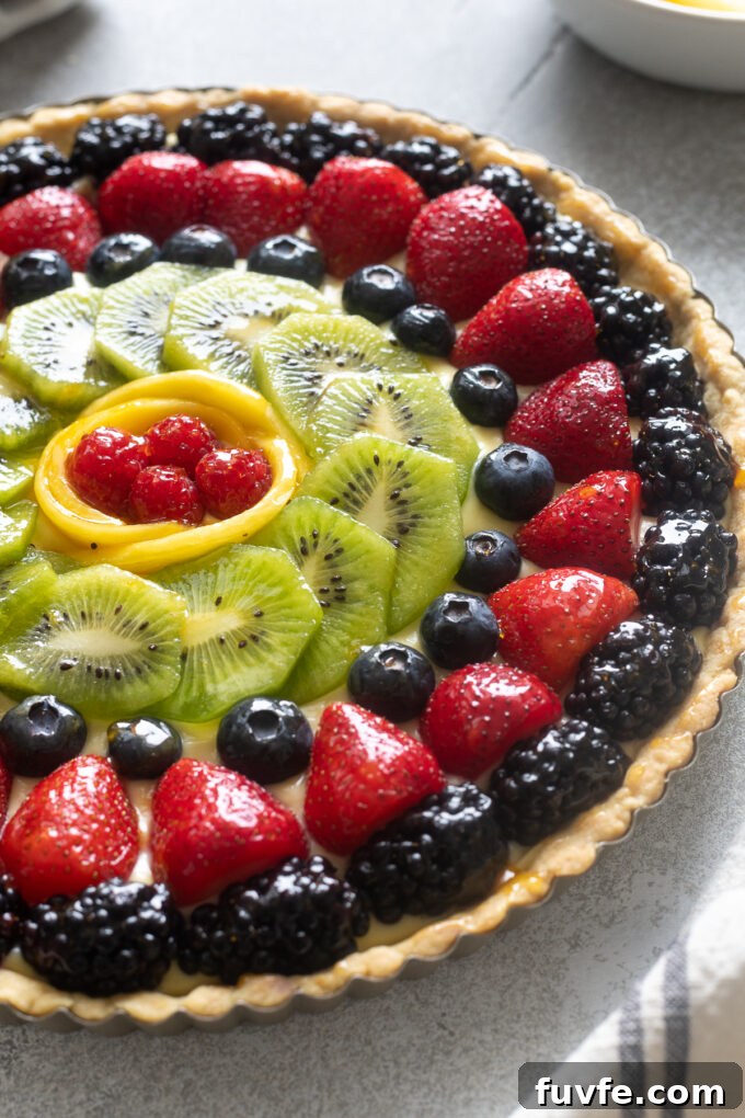 Fresh fruit tart with berries, kiwi and mango.