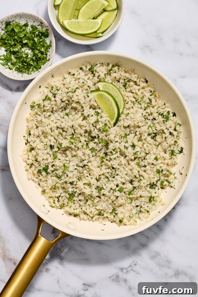 Riced cauliflower with cilantro and lime in a skillet.