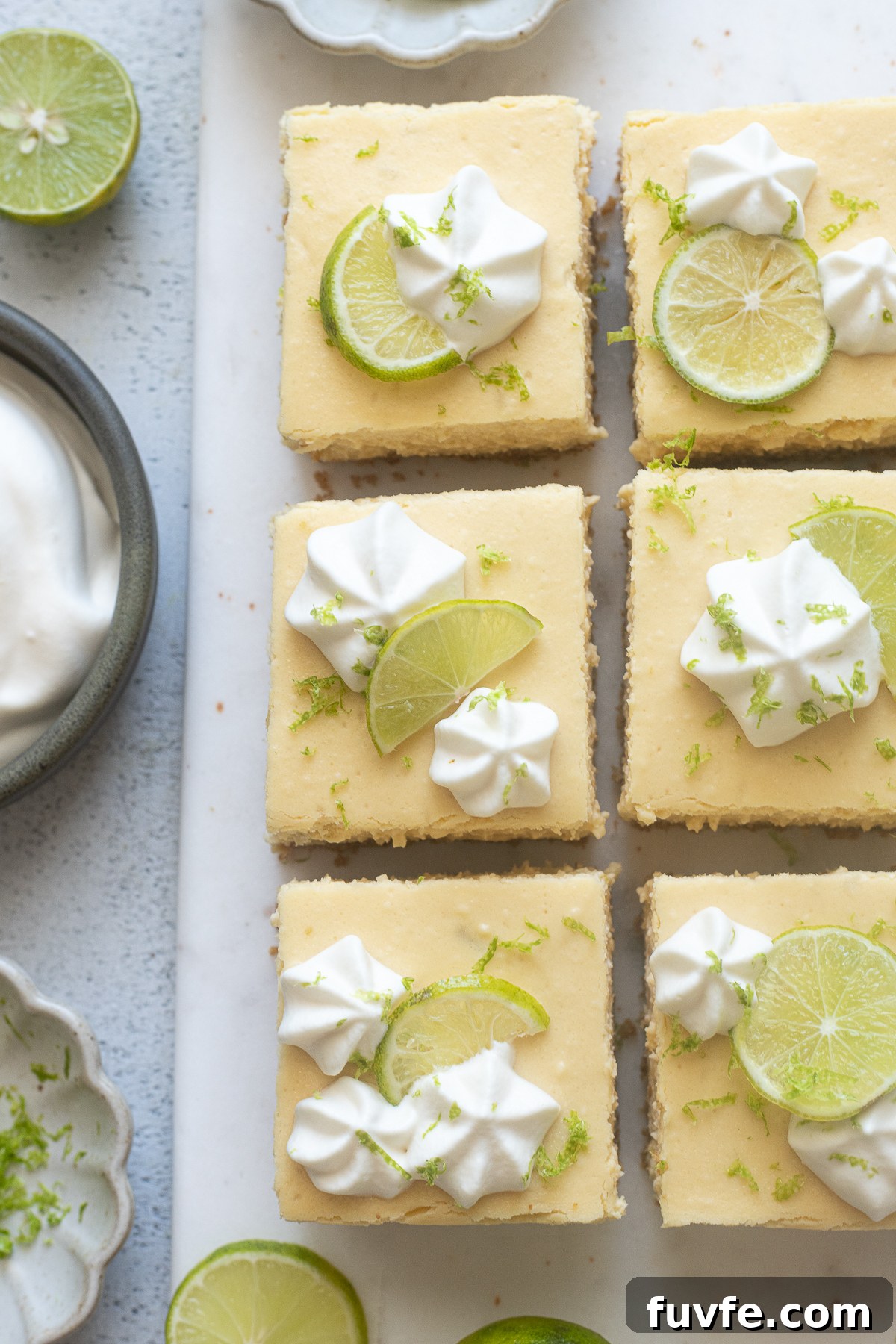 Key lime cheesecake bars cut into squares.