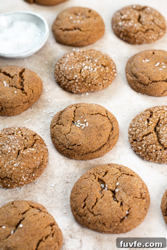 Array of gingersnap cookies with a bowl of sparkle sugar