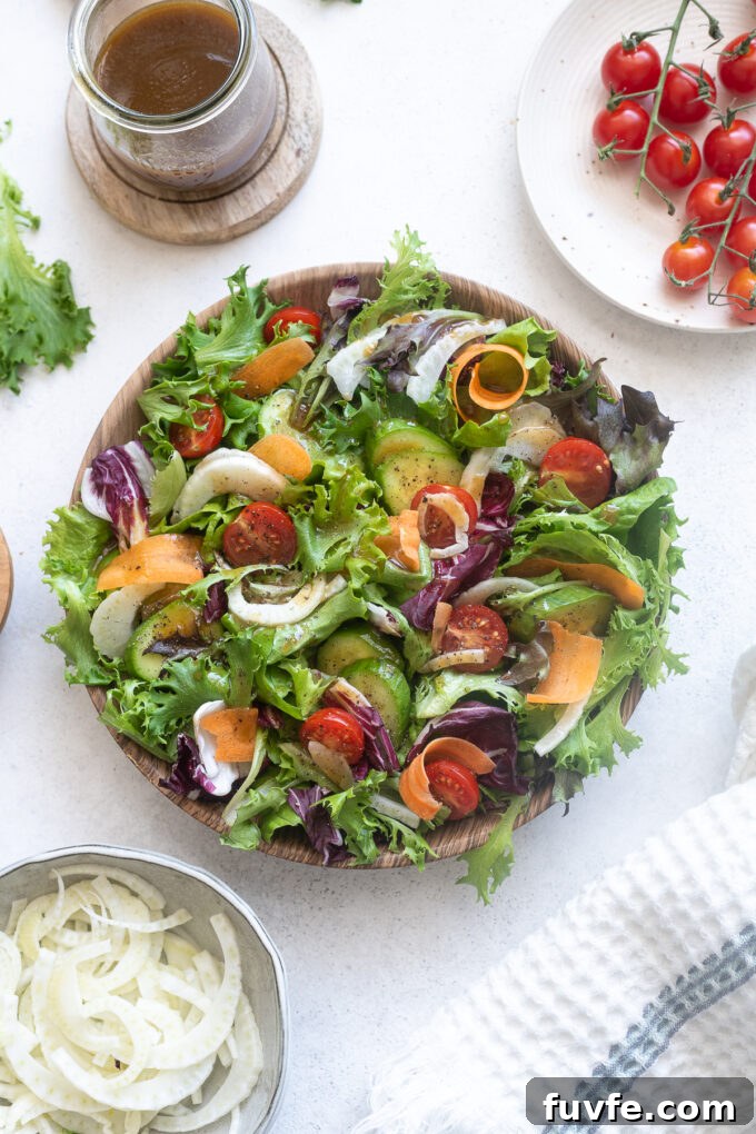 Italian mixed green salad with tomatoes and fennel.