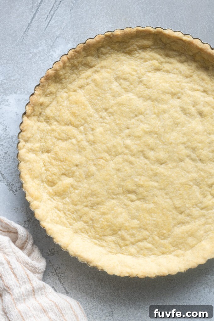 Sweet tart dough in a tart pan.