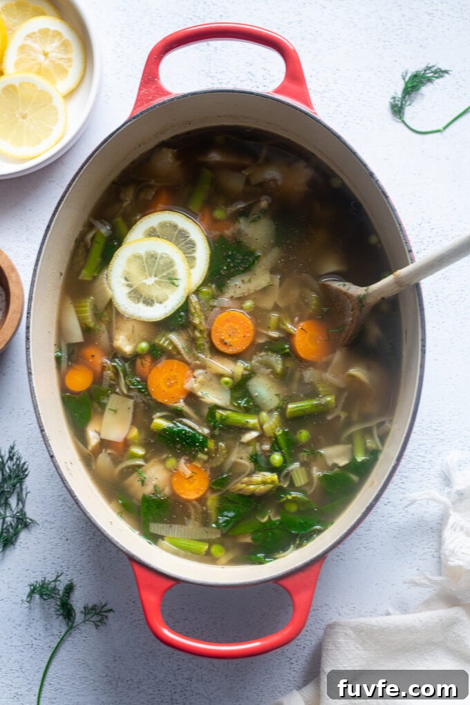 Bright Spring Vegetable Soup Recipe with Fresh Herbs 3 Healthy spring soup in a Dutch oven with lemon and dill.
