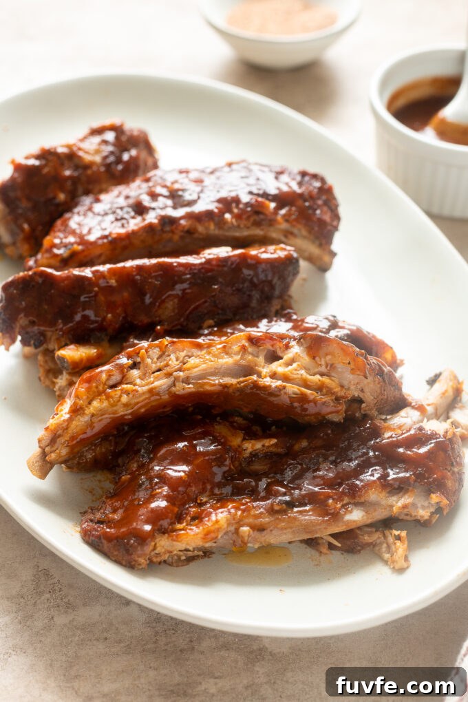 Fall-Off-the-Bone Slow-Cooker Baby Back Ribs 11 Slow cooker bbq baby back ribs cut on a platter.