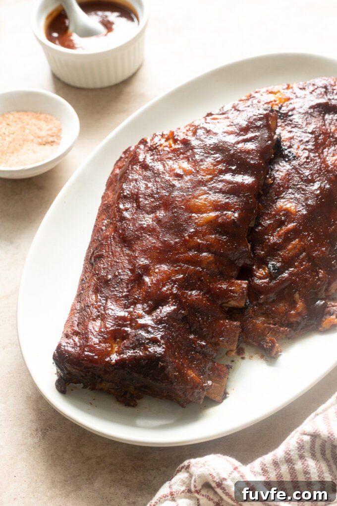Fall-Off-the-Bone Slow-Cooker Baby Back Ribs 3 Slow cooker bbq pork ribs on a platter.