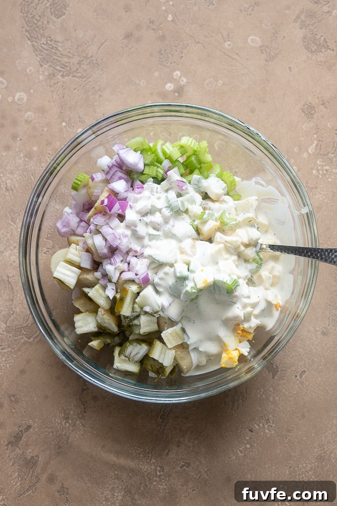 Potato salad ingredients in a mixing bowl.