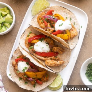 Air Fryer Chicken Fajitas Recipe: 20-Minute Dinner 11 Air fryer chicken fajitas on a platter with toppings.