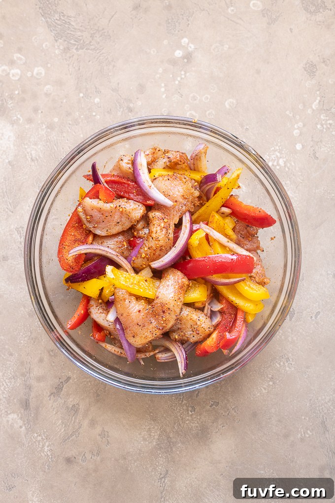 Air Fryer Chicken Fajitas Recipe: 20-Minute Dinner 7 Toss the fajita chicken and vegetables with oil and seasoning.