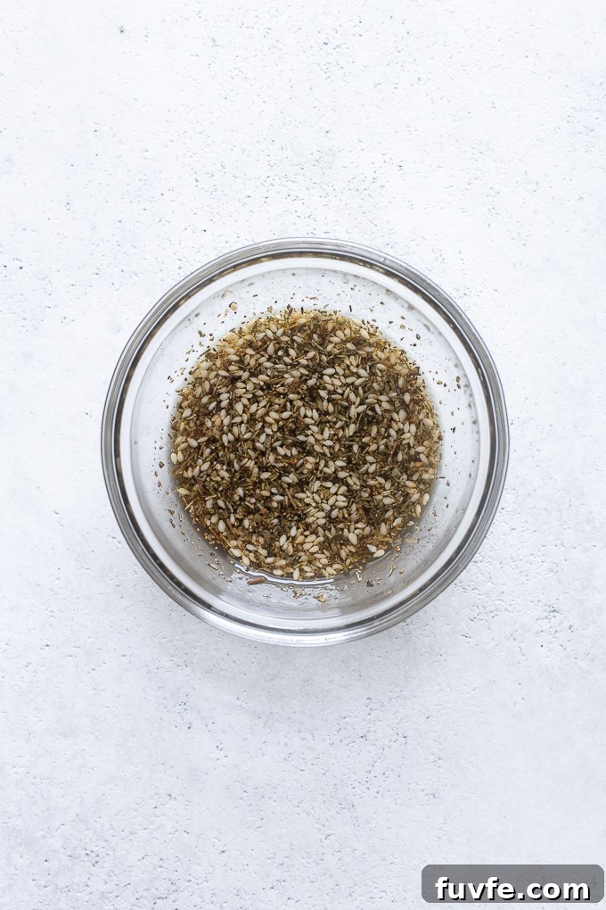 Za'atar seasoning combined with olive oil in a small bowl.