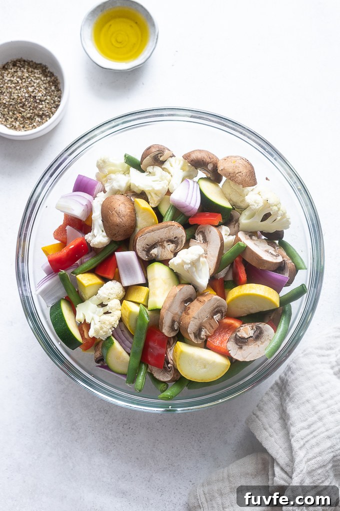 Prepped veggies for air fryer roasted vegetables in a mixing bowl.