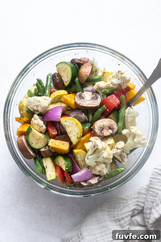 Vegetables tossed with olive oil and za'atar spice before air frying.