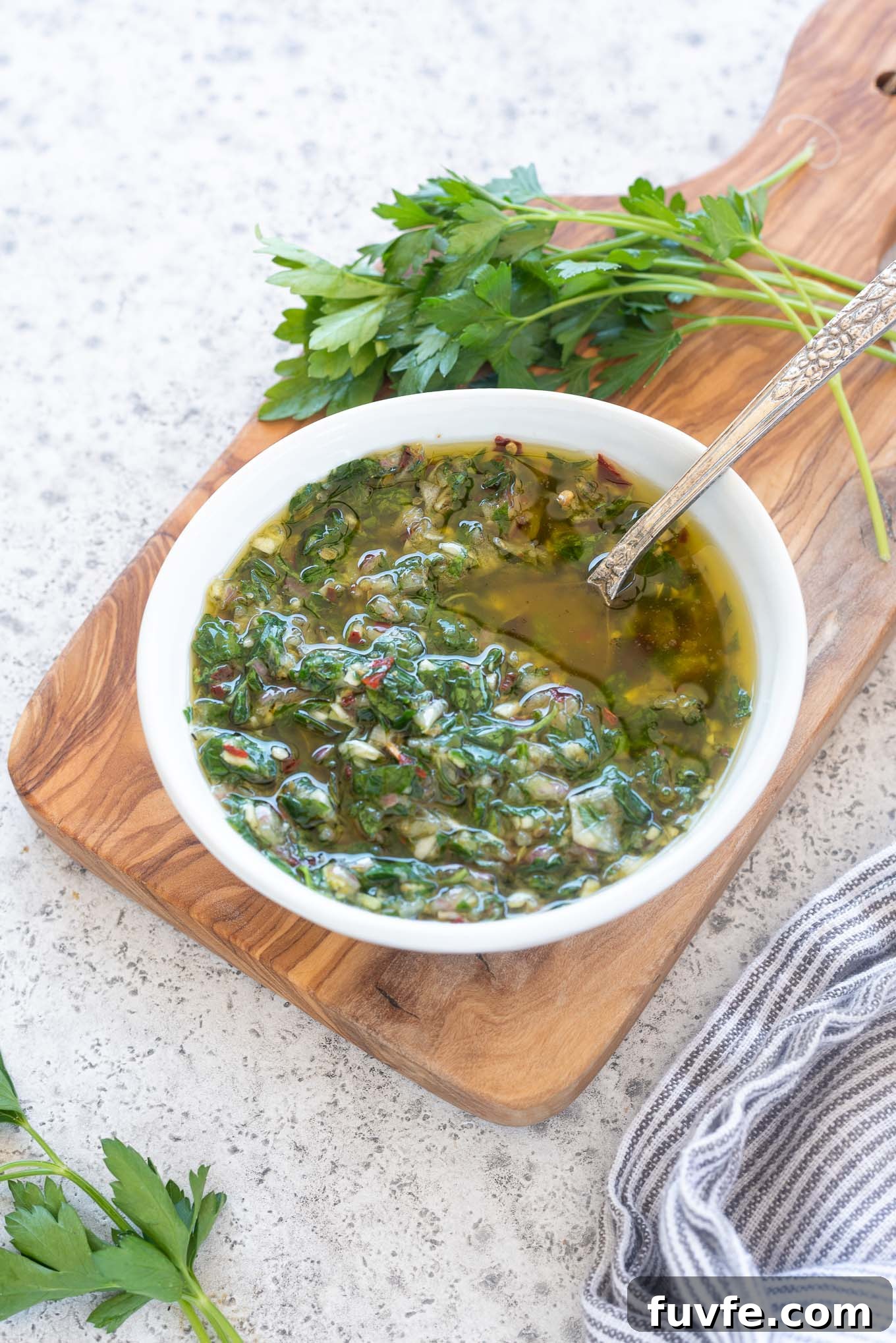 July Produce Guide: What's in Season 9 Chimichurri sauce in a bowl with a spoon inside