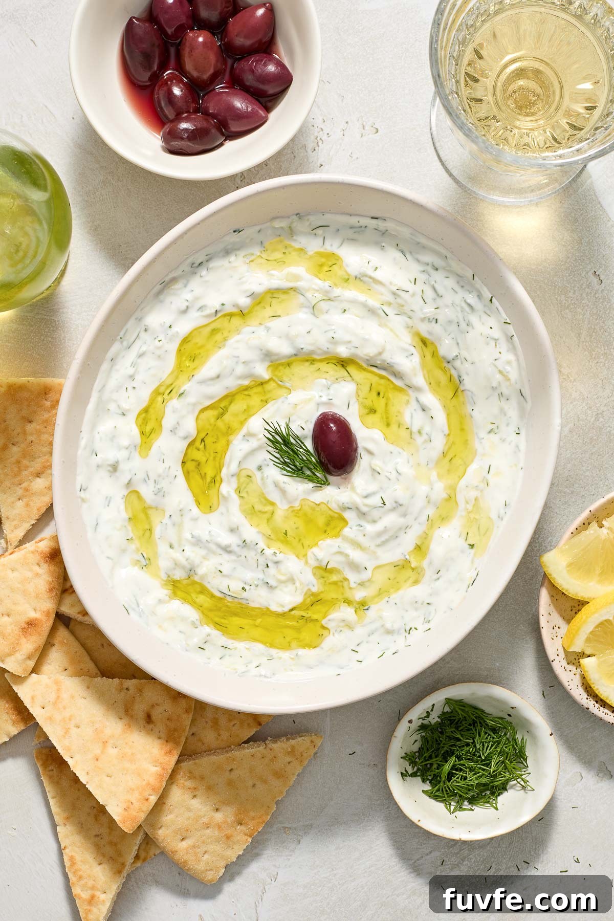 July Produce Guide: What's in Season 10 Greek tzatziki in a bowl with olive oil and dill.