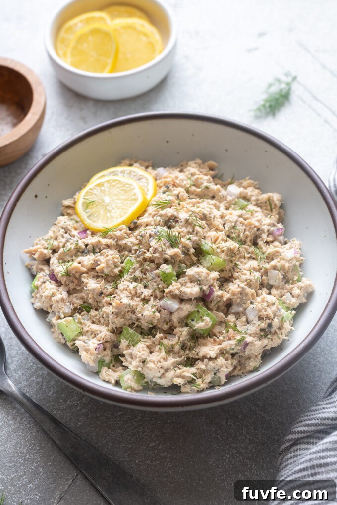 Creamy Canned Salmon Salad Recipe with Lemon and Dill 2 Canned salmon salad in a serving bowl with lemon.