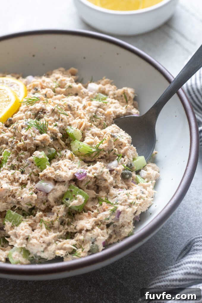 Creamy Canned Salmon Salad Recipe with Lemon and Dill 9 Serving spoon digging into canned wild salmon salad.
