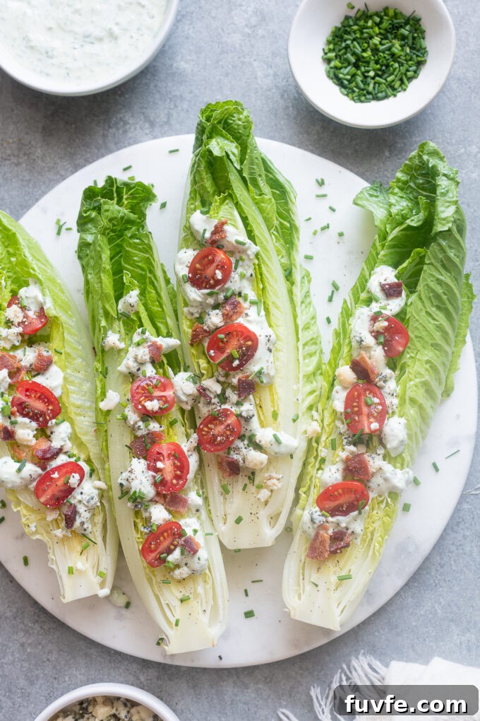 Romaine wedge salads with goddess dressing on a platter.
