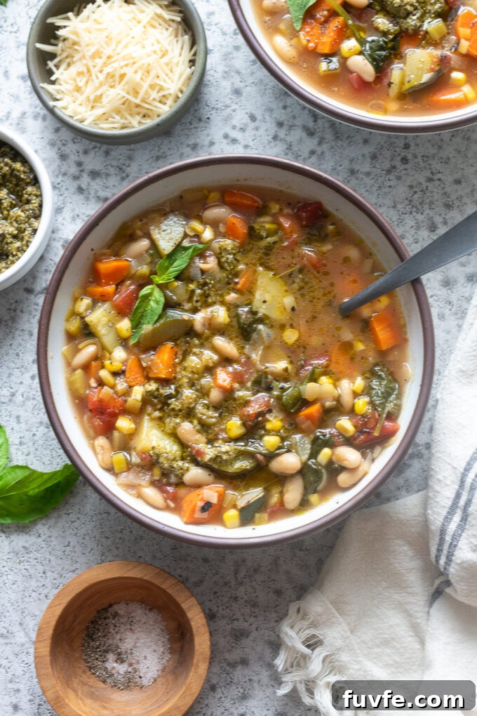 Soupe au pistou in a bowl with basil sprig.