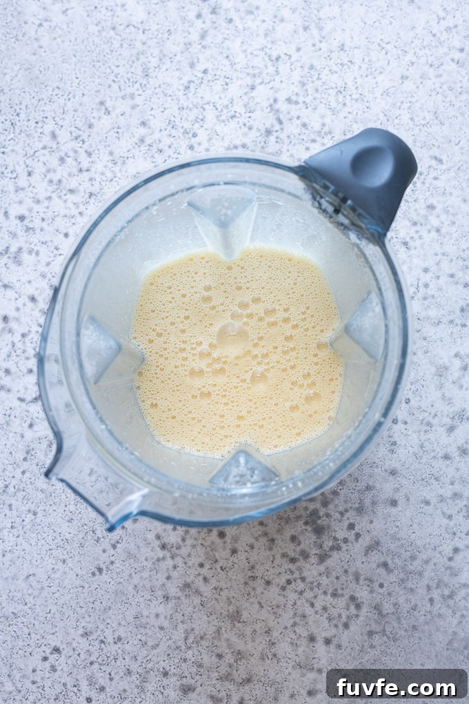 Cherry clafoutis batter combined in a blender.