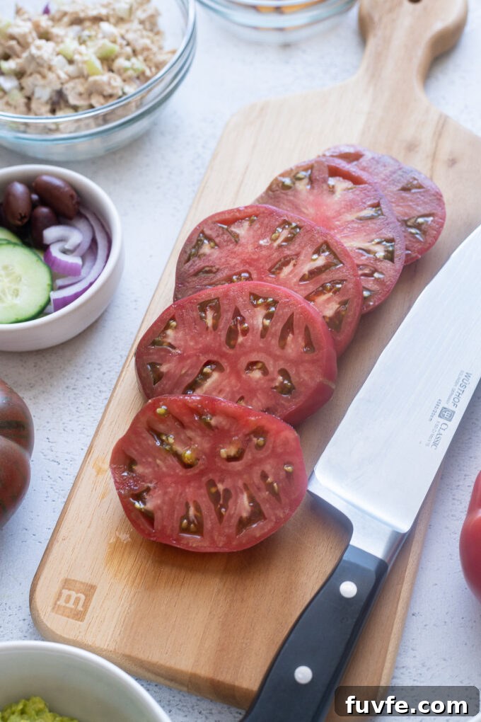Sliced heirloom tomatoes on a wooden board for heirloom tomato flight.