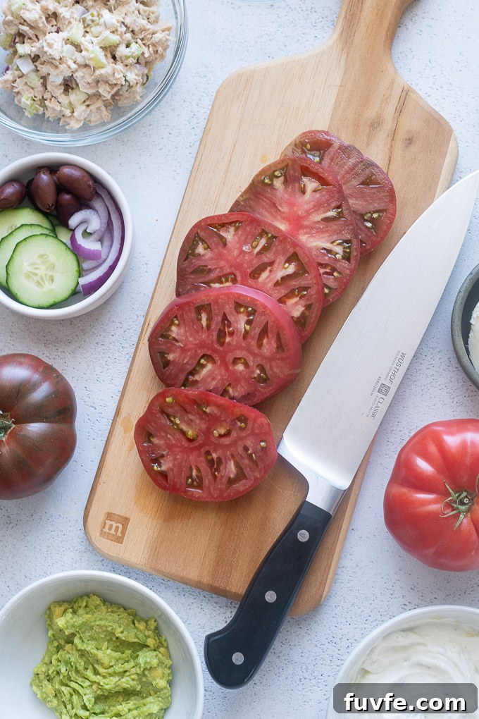Sliced heirloom tomatoes on a wooden cutting board.