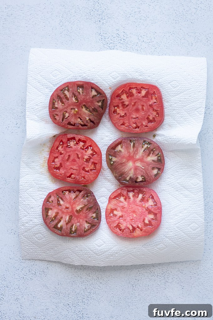 Slices or heirloom tomato on paper towels.