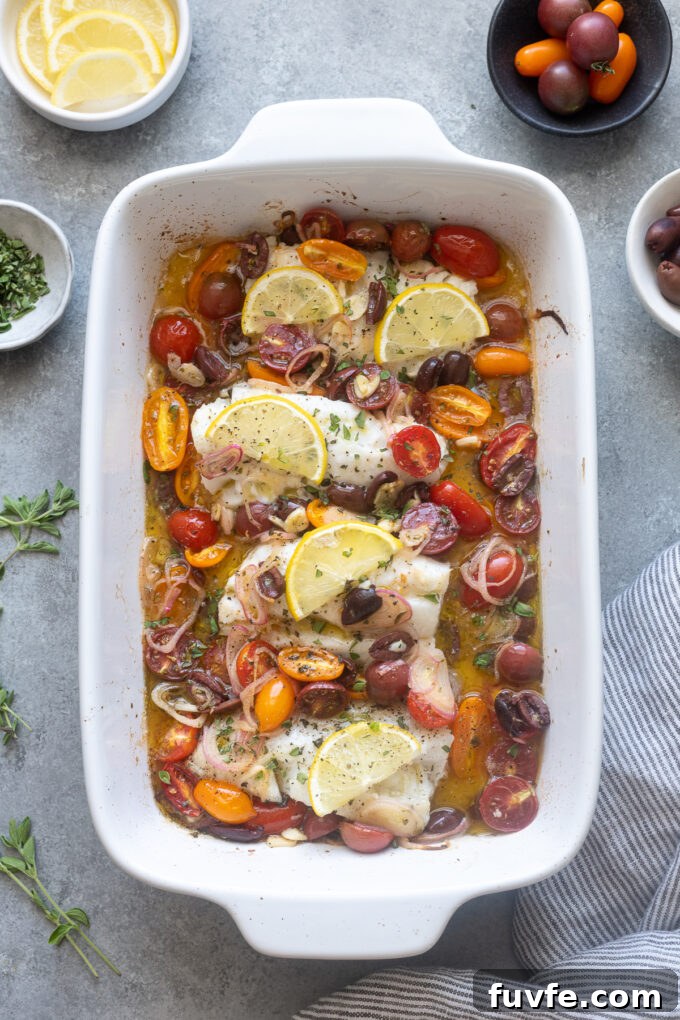 Mediterranean Baked Cod with Cherry Tomatoes, Olives and Lemon 2 Mediterranean baked cod in baking dish.