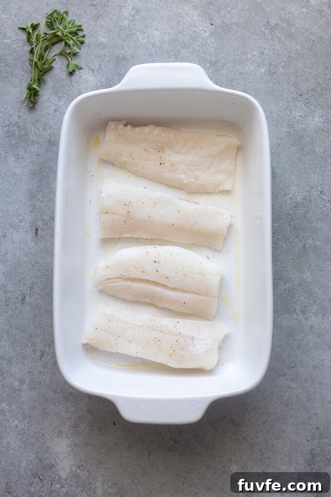 Mediterranean Baked Cod with Cherry Tomatoes, Olives and Lemon 6 Place cod fish in baking dish and season.
