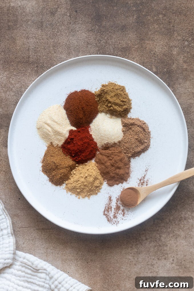 10 essential spices sectioned on a round white plate.