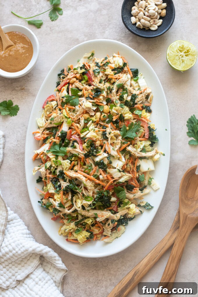 Thai peanut chicken salad on a platter with peanut dressing.