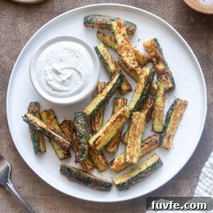 Crispy Air Fryer Zucchini Fries 11 Air fryer zucchini fries on a plate with Greek yogurt ranch dip.