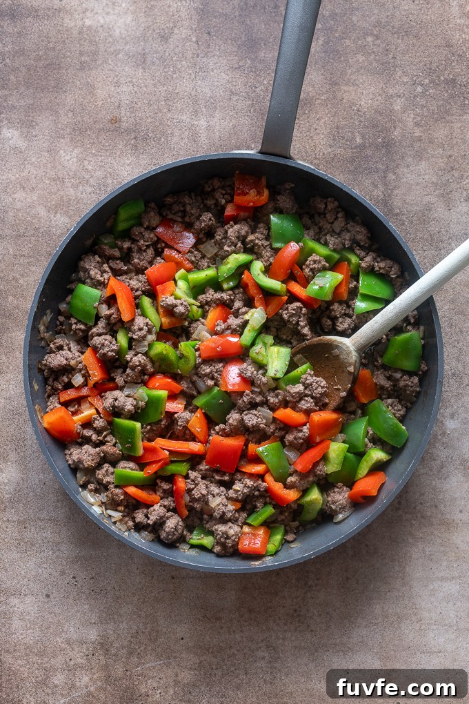 Cooked beef and bell peppers for stuffed pepper casserole.
