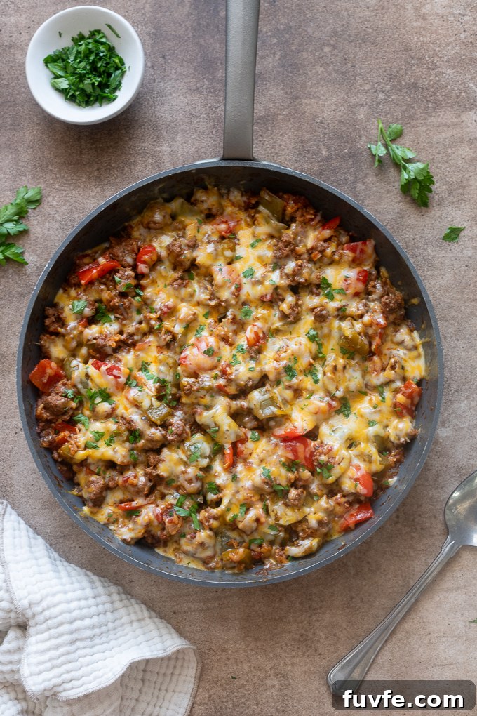 Stuffed pepper casserole topped with melted cheese and parsley.