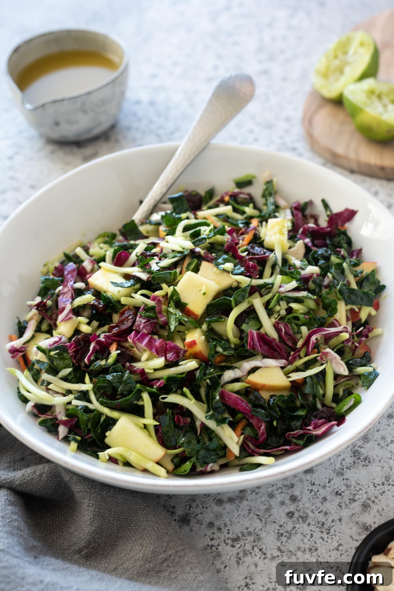October Produce Guide: Fruits and Vegetables in Season 16 Kale slaw in a white bowl with honey lime dressing