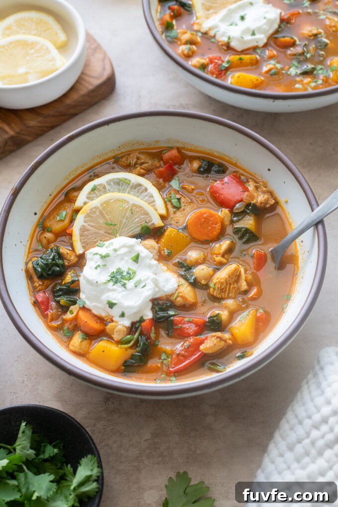 Moroccan chicken soup in a bowl with a dollop of Greek yogurt.