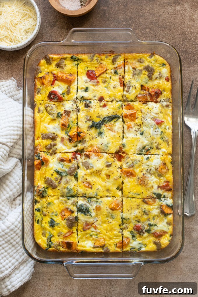 Overnight Sausage and Egg Breakfast Casserole 2 Sausage and egg breakfast casserole sliced in baking dish.