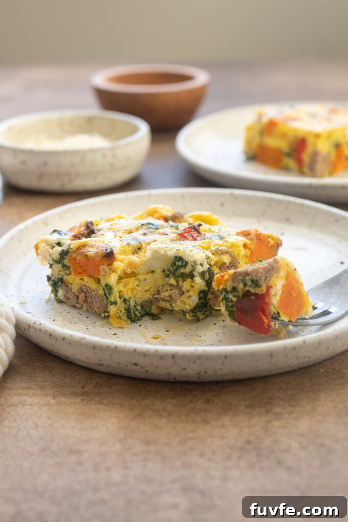 Overnight Sausage and Egg Breakfast Casserole 12 Slice of Sweet potato and sausage egg bake on a plate.