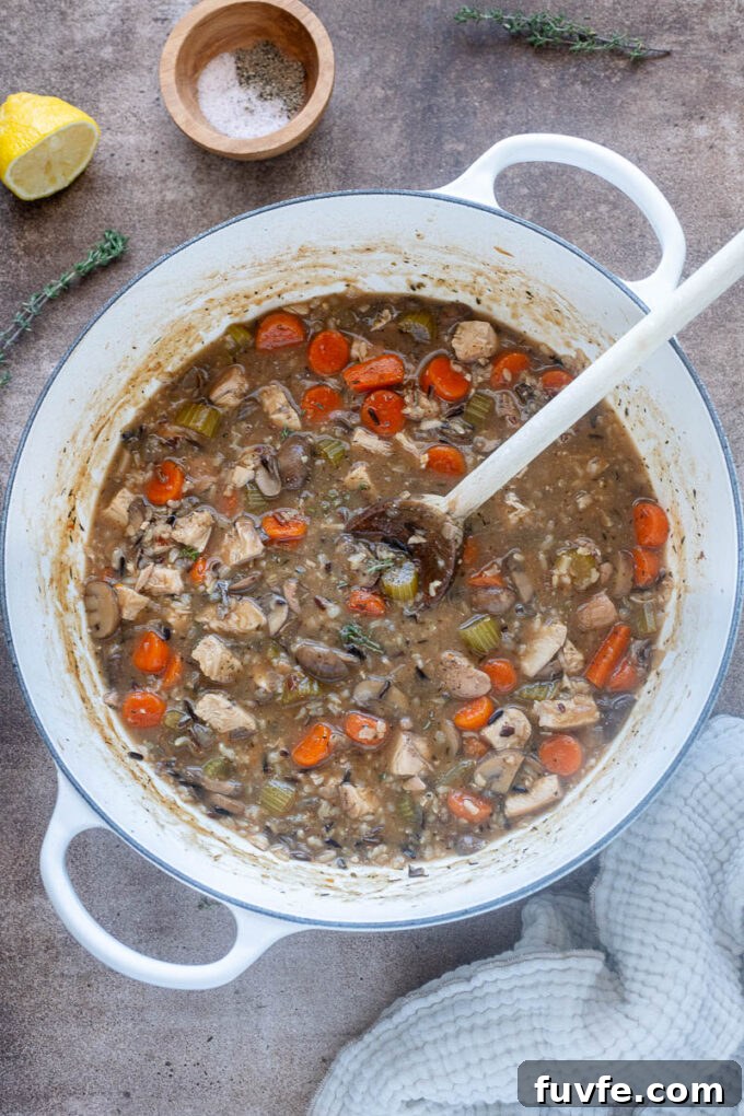Chicken and wild rice soup in a Dutch oven.