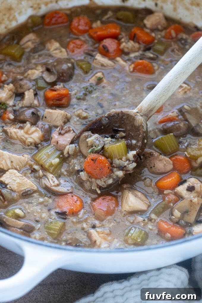 Stovetop chicken and wild rice soup in a Dutch oven.