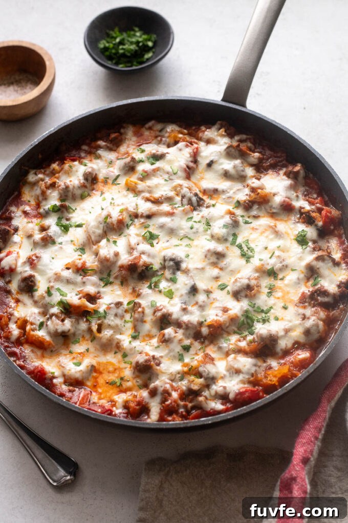 Spaghetti squash casserole with ground beef and cheese in a skillet.