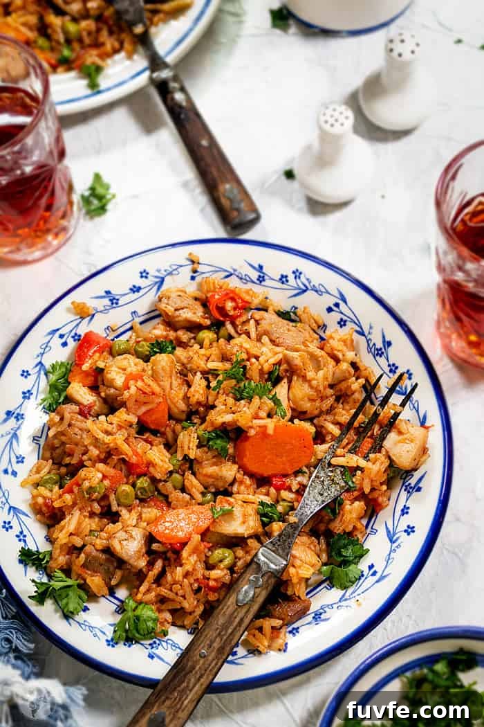 One-Pan Chicken and Rice with Garden Vegetables 2 Chicken risotto in a plate with a fork