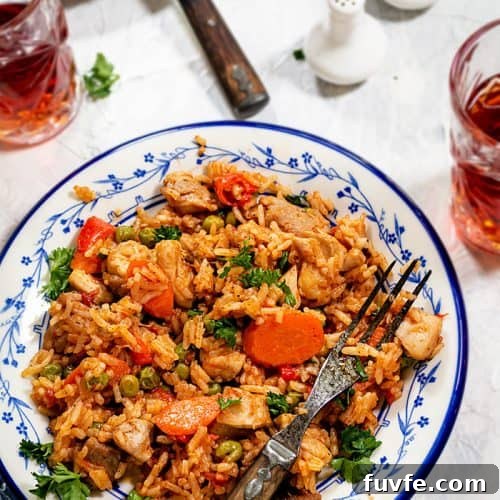 One-Pan Chicken and Rice with Garden Vegetables 8 Chicken risotto in a plate with a fork