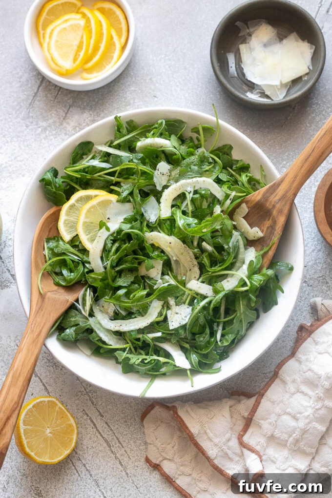 Fennel arugula salad tossed in a bowl.