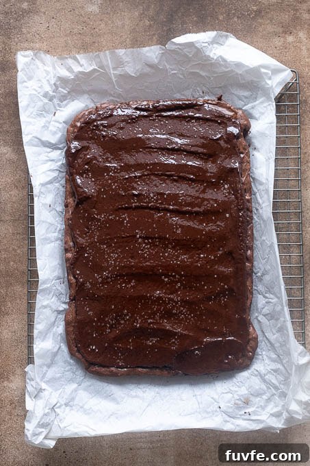 Cooled brownies topped with chocolate ganache and sea salt.