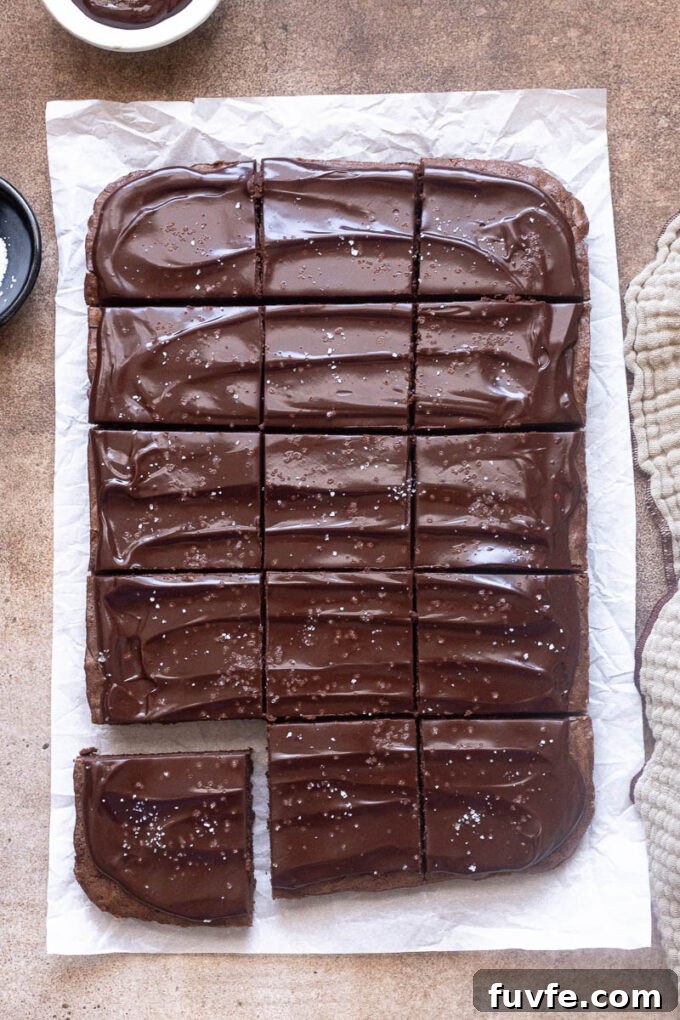Cocoa brownies baked in a 9x13 inch pan and topped with chocolate ganache.